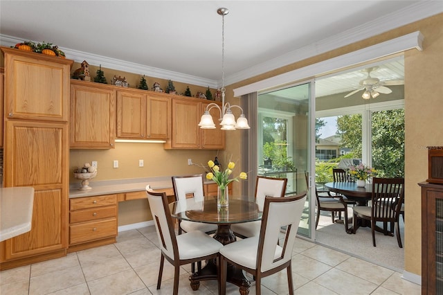 dining area with light colored carpet, crown molding, built in desk, and ceiling fan with notable chandelier