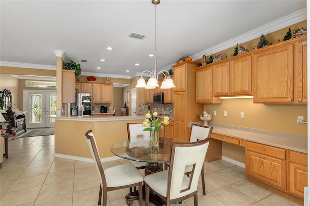 dining area with crown molding, french doors, built in desk, and light tile patterned floors