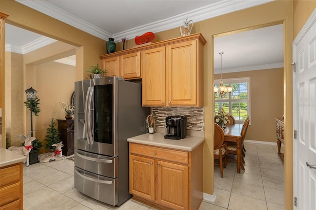 kitchen featuring decorative backsplash, light tile patterned floors, a chandelier, crown molding, and stainless steel refrigerator with ice dispenser