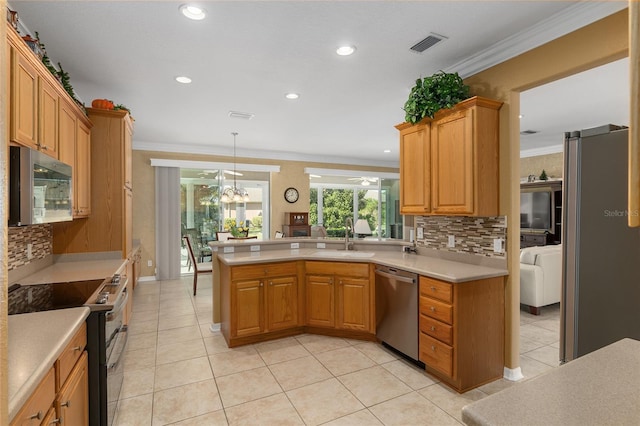 kitchen featuring appliances with stainless steel finishes, sink, hanging light fixtures, crown molding, and decorative backsplash