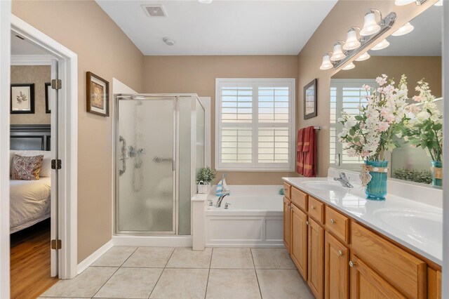 bathroom with vanity, shower with separate bathtub, and tile patterned flooring