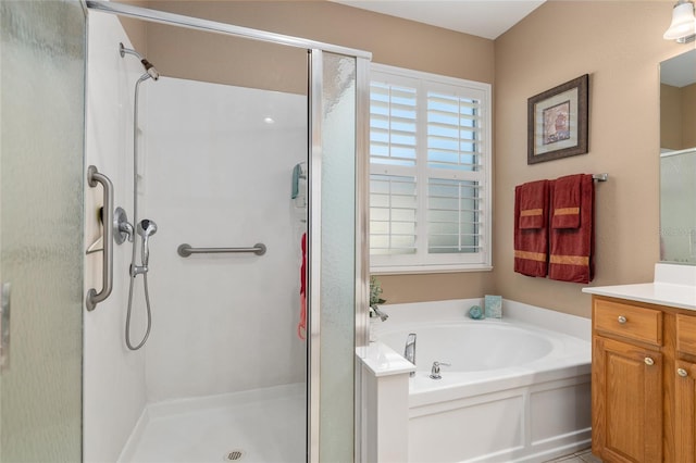 bathroom with vanity and shower with separate bathtub