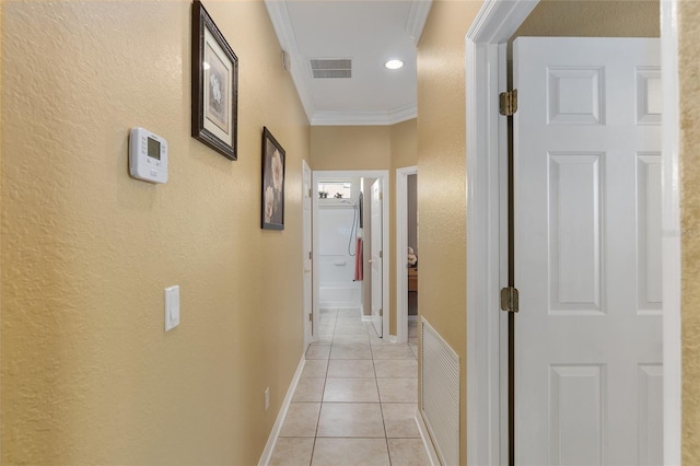 hall featuring ornamental molding and light tile patterned floors