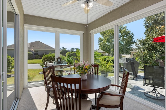 sunroom / solarium featuring wood ceiling and ceiling fan