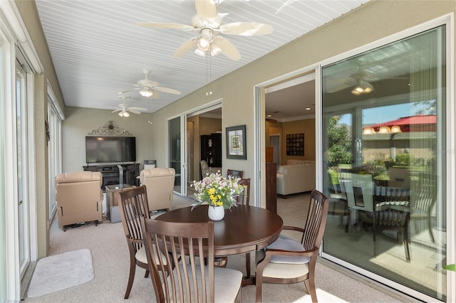 dining room featuring light carpet and ceiling fan