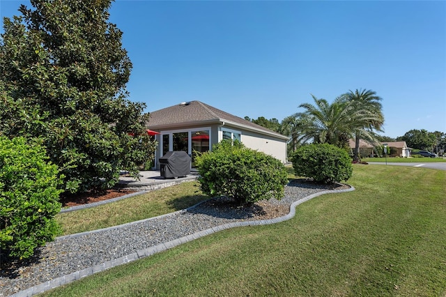 view of front facade with a front yard and a patio