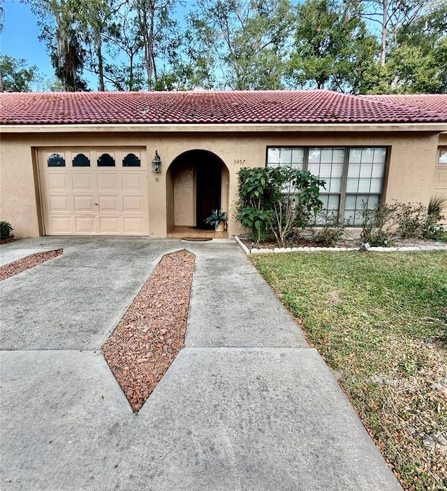 view of front facade with a garage and a front lawn