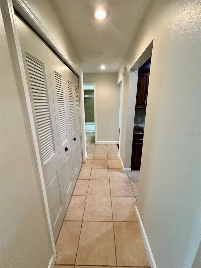 corridor featuring light tile patterned floors