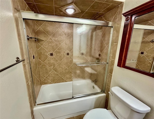 bathroom with shower / bath combination with glass door and toilet