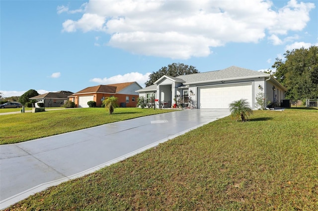 single story home featuring cooling unit, a front yard, and a garage