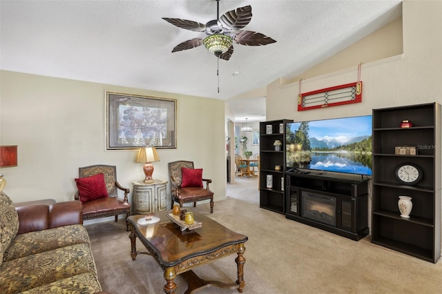 living room featuring a textured ceiling, light colored carpet, vaulted ceiling, and ceiling fan