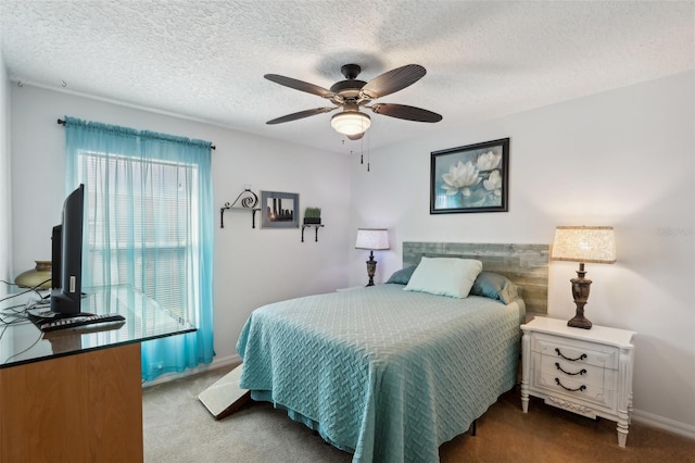 carpeted bedroom featuring ceiling fan and a textured ceiling