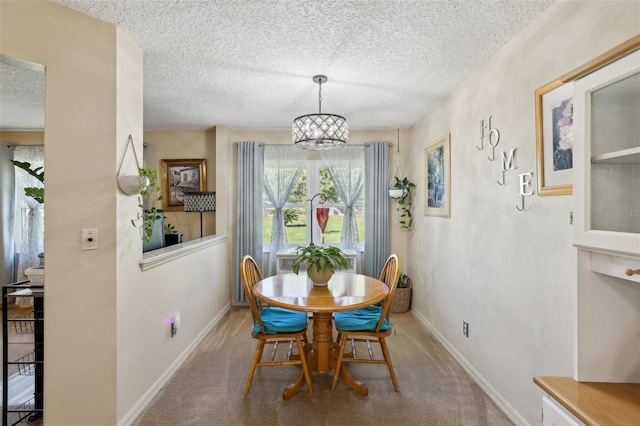 carpeted dining area featuring a chandelier