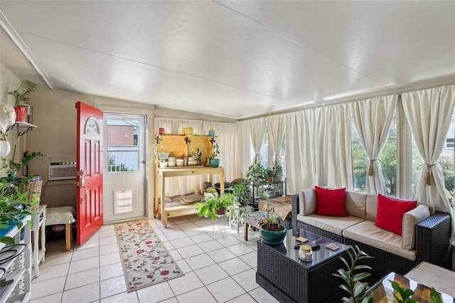 sunroom with a wall mounted AC and vaulted ceiling