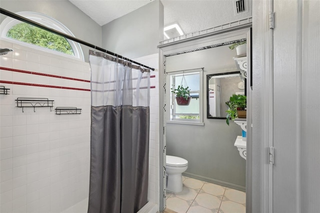 bathroom featuring tile patterned floors, a shower with curtain, and toilet