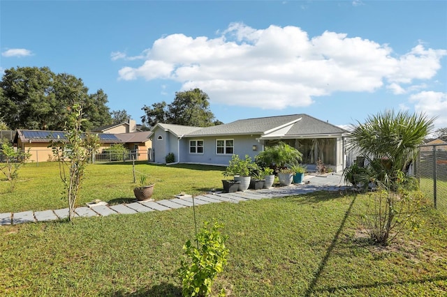 rear view of house featuring a yard