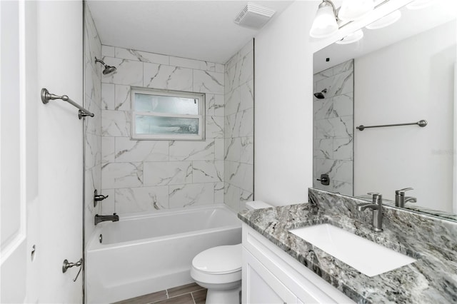 full bathroom with hardwood / wood-style flooring, vanity, toilet, and tiled shower / bath combo