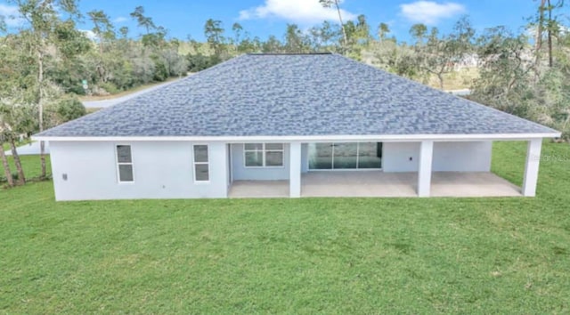 rear view of house with a yard and a patio area