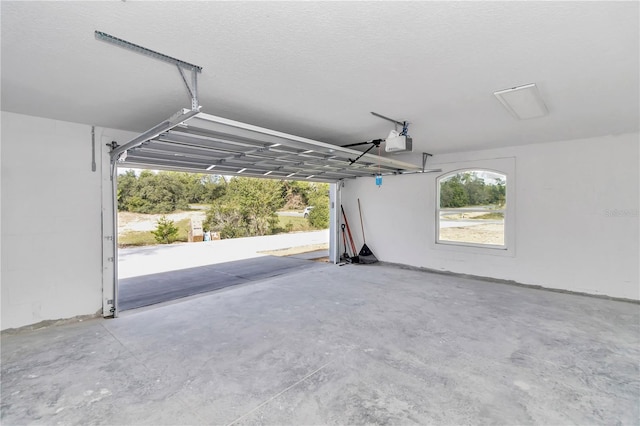 garage featuring a garage door opener and a carport