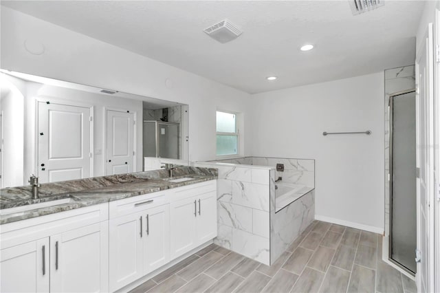 bathroom with independent shower and bath and vanity