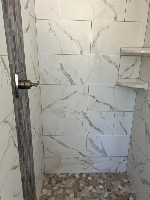 bathroom with tiled shower