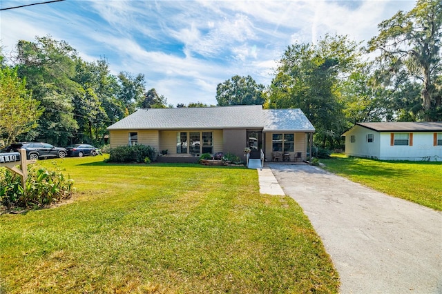 ranch-style house with a front yard and a porch