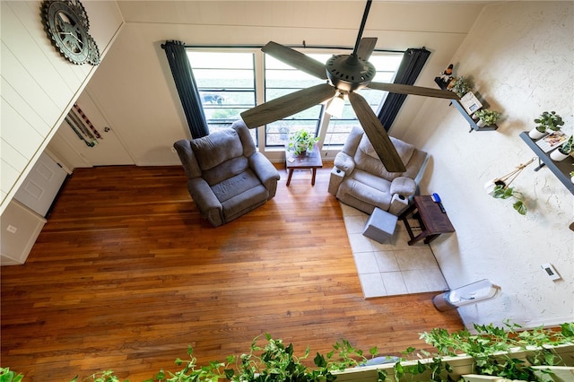 unfurnished living room featuring hardwood / wood-style flooring and ceiling fan