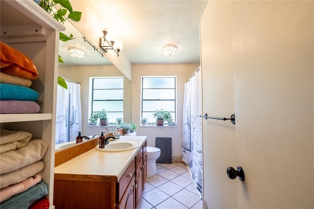 bathroom with vanity, toilet, and tile patterned floors