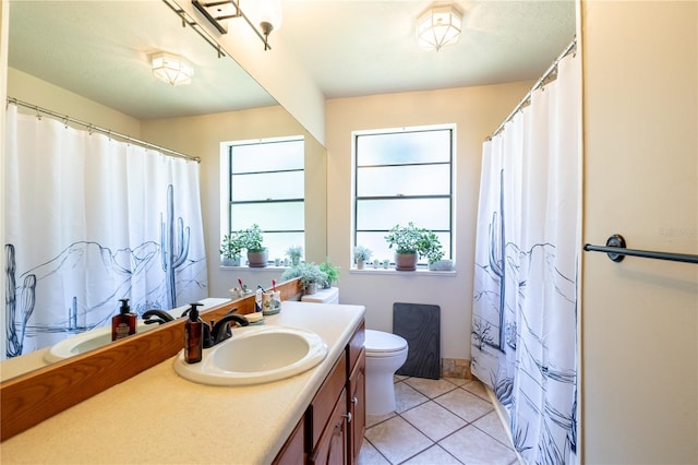 bathroom with vanity, toilet, and tile patterned flooring