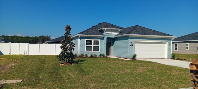 view of front of home with a front yard and a garage