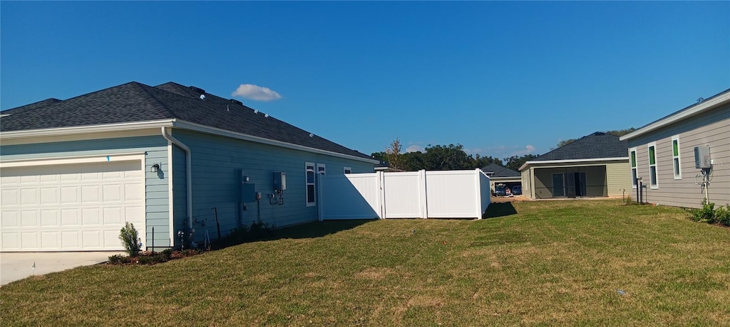 view of property exterior featuring a yard and a garage