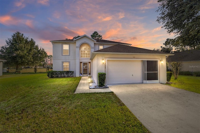 view of front of house featuring a garage and a lawn