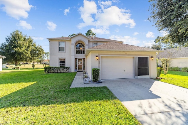 view of front of property featuring a front yard and a garage