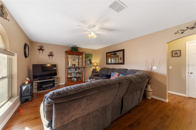 living room with dark hardwood / wood-style floors and ceiling fan