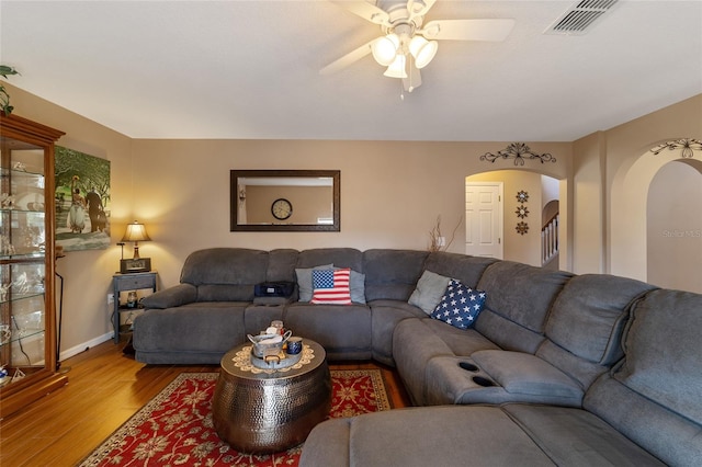 living room featuring ceiling fan and hardwood / wood-style flooring