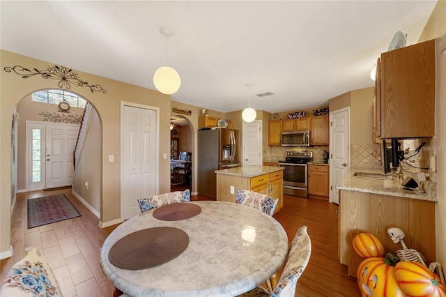 dining space featuring sink and hardwood / wood-style flooring