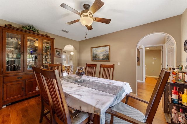 dining area with ceiling fan and hardwood / wood-style flooring