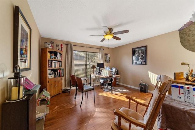 living area featuring hardwood / wood-style flooring and ceiling fan