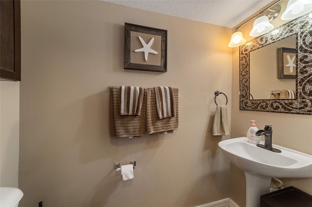 bathroom featuring a textured ceiling and toilet