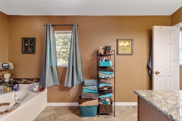 bathroom featuring vanity and a tub to relax in