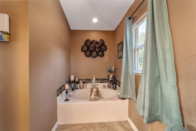 bathroom with a relaxing tiled tub