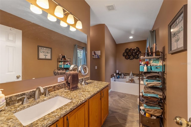 bathroom featuring vanity and a tub