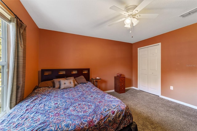 carpeted bedroom featuring a closet and ceiling fan