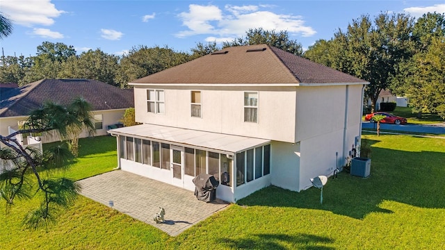 back of house with a yard, a sunroom, and central AC unit