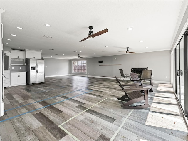 living room featuring hardwood / wood-style floors, a textured ceiling, and ceiling fan