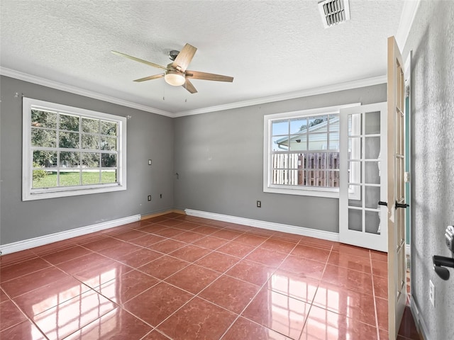 tiled spare room with ornamental molding, a textured ceiling, and ceiling fan