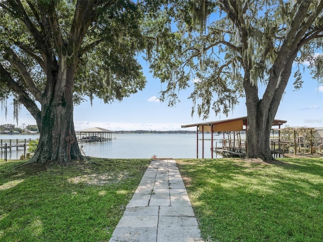 dock area featuring a water view and a yard