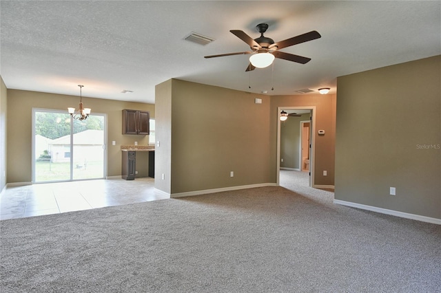 unfurnished living room featuring ceiling fan with notable chandelier, a textured ceiling, and light colored carpet