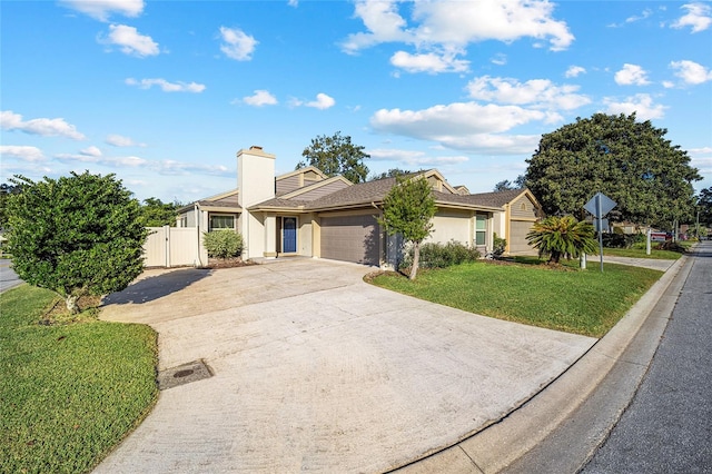 ranch-style house featuring a front yard and a garage