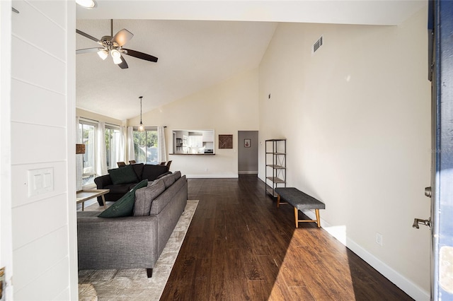 living room featuring high vaulted ceiling, dark wood-type flooring, and ceiling fan